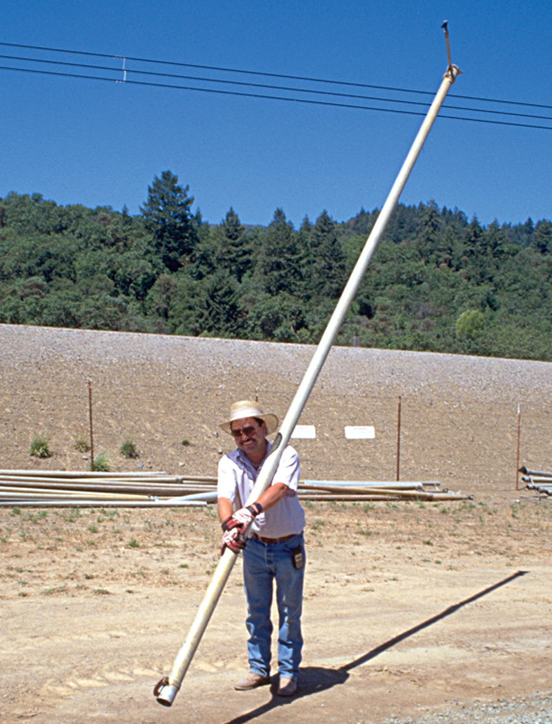 Worker carrying irrigation pipe